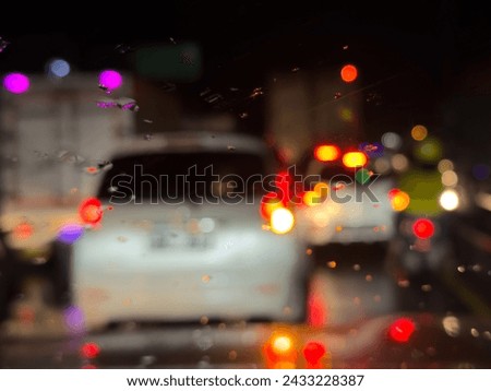 car traffic lights on night road with blur or bokeh background Royalty-Free Stock Photo #2433228387