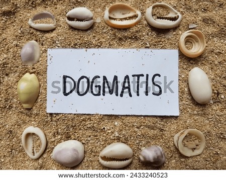 Dogmatis writting on beach sand background.