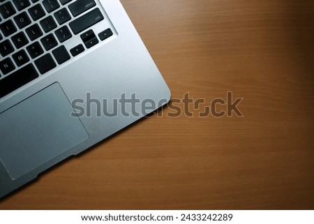 A business desk table with a laptop. Wood background with copy space.