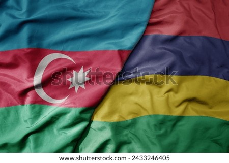 big waving national colorful flag of mauritius and national flag of azerbaijan. macro