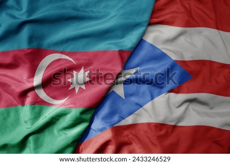 big waving national colorful flag of puerto rico and national flag of azerbaijan. macro