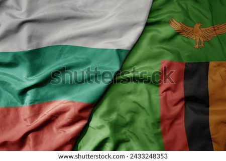 big waving national colorful flag of zambia and national flag of bulgaria . macro