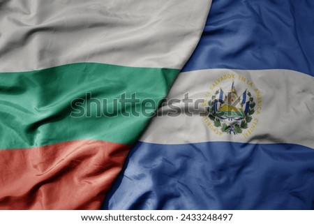 big waving national colorful flag of el salvador and national flag of bulgaria . macro