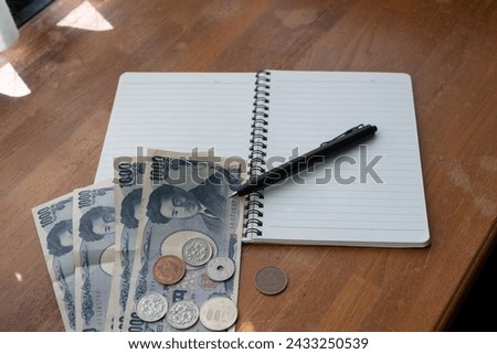 Japanese yen cash and blank notebook