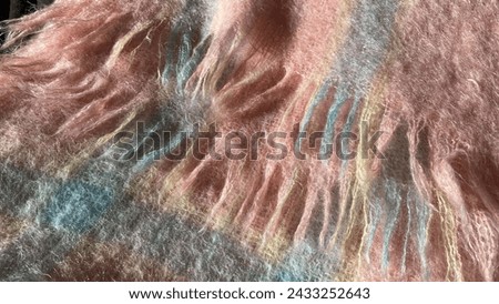 Mohair. Pink wool texture mohair scarf with fringe. warm knitted blanket with pink and blue geometric pattern