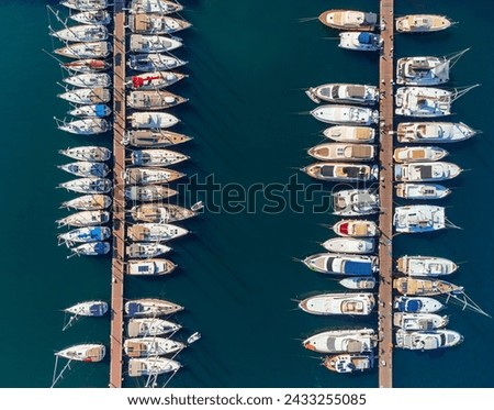 Aerial view of rows of yachts in Fethiye Marina, Turkey. Drone flying over the marina. Fethiye is a popular tourist destination in the Turkish Riviera. Royalty-Free Stock Photo #2433255085
