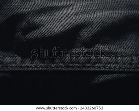 Dark jeans texture at night for a super cool fashion background.  Royalty-Free Stock Photo #2433260753