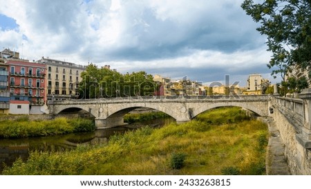View of the stone bridge "Pont de Pedra" over the Onyar river in the city of Girona Royalty-Free Stock Photo #2433263815