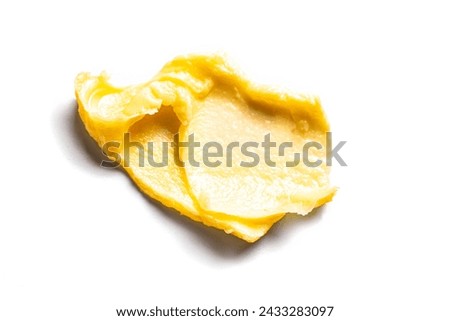 Yellow cosmetic cream swatch smear smudge isolated on white background. Stroke of rich body butter,  clay cosmetic product. Royalty-Free Stock Photo #2433283097
