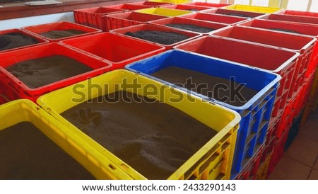 Colorful sand containers. Action. Colorful sand containers stored in warehouse in southern country. Sand in containers for business in southern regions