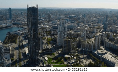 Top view of landscape of modern city with horizon. Stock footage. Summer in modern city with beautiful architecture and greenery in summer. Panorama of city with river and modern skyscrapers