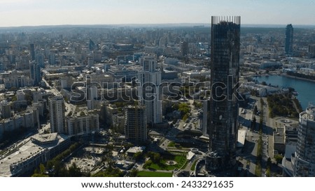 Top view of landscape of modern city with horizon. Stock footage. Summer in modern city with beautiful architecture and greenery in summer. Panorama of city with river and modern skyscrapers