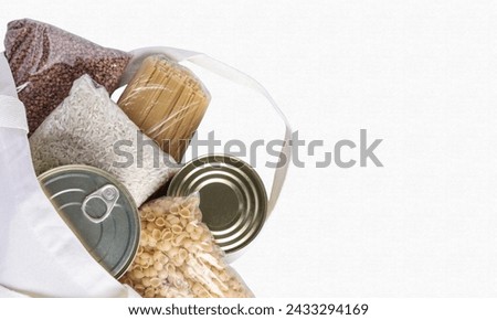 Food delivery, donation, textile grocery bag with food supplies crisis food stock for quarantine isolation period on white. copy space for text