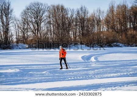 Skier skiing in the snow in the park, healthy outdoor recreation outside the city in winter. High quality photo