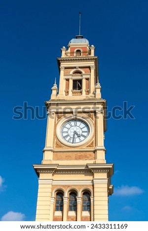 The traditional clock in the Luz station tower, on the terrace of the building that houses the Portuguese language museum, in the city of São Paulo Royalty-Free Stock Photo #2433311169