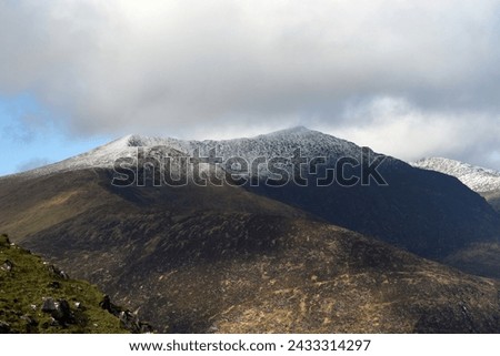 View from Conor Pass on a cold March day, witth a snow capped Mont Brendon Royalty-Free Stock Photo #2433314297