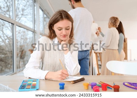 Female student drawing in art school