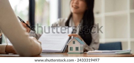 Customer meet and negotiation with real estate agents about renting, buying home, Real estate agent negotiate, talk about the terms of the home purchase agreement and asked customer to sign contract