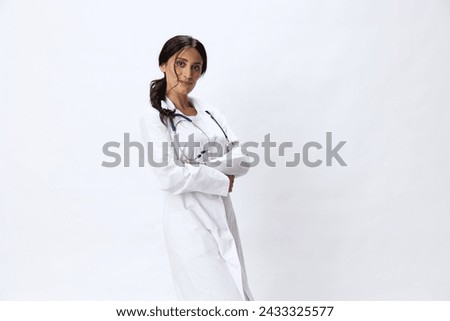 Woman doctor with stethoscope in hand in medical gown on white nurse background, consequences of covid-19, noise in lungs, concept of health and science