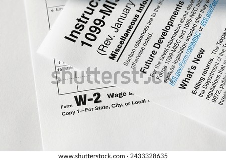 1099 Misc. and W2 Internal Revenue Service tax forms. Royalty-Free Stock Photo #2433328635