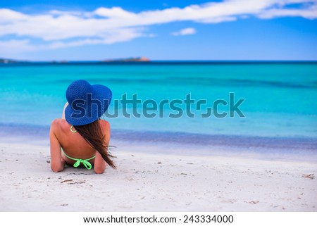 Back view of woman at tropical beach during summer vacation