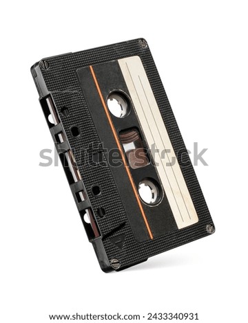 Black plastic audio compact cassette tape isolated on white background. 80's mixtape symbol.