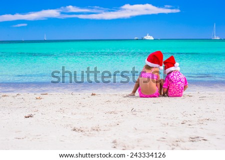 Little girls in Santa hats during summer vacation