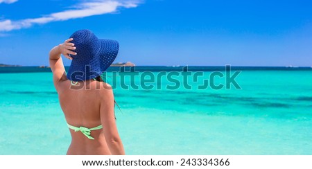 Young beautiful girl relaxing at tropical beach during summer vacation