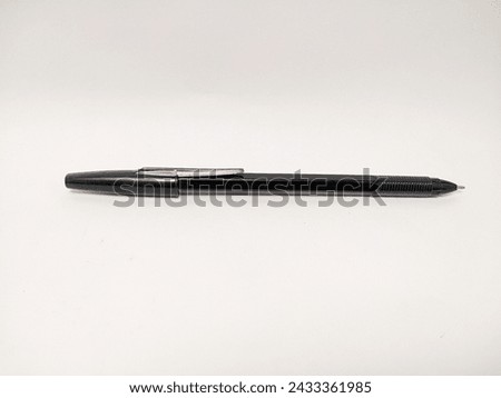 Ballpoint pen: a writing instrument whose tip uses a small rotating ball to regulate the release of thick ink stored in a cylindrical column. The tip of the ballpoint pen is a small ball Royalty-Free Stock Photo #2433361985