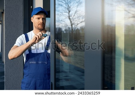 worker installing and adjusting aluminum frame sliding terrace doors