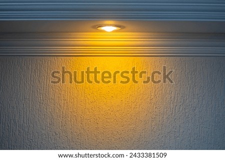 Background scene with wall and spot lit with yellow light. Special background image for artwork