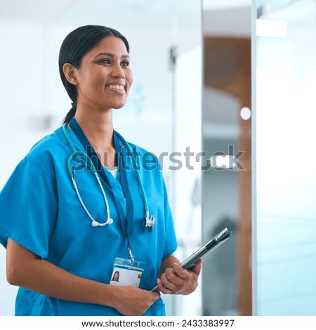 Portrait Of Female Doctor Or Nurse With Digital Tablet Checking Patient Notes In Hospital