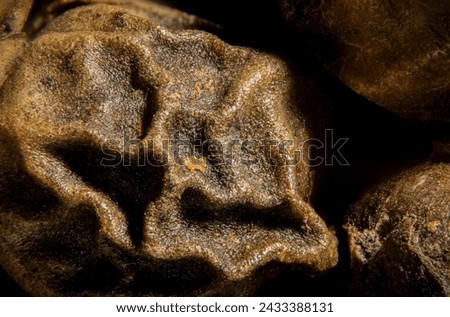 Close-up of peppercorns commonly used as a spice and seasoning in various cuisines. Royalty-Free Stock Photo #2433388131