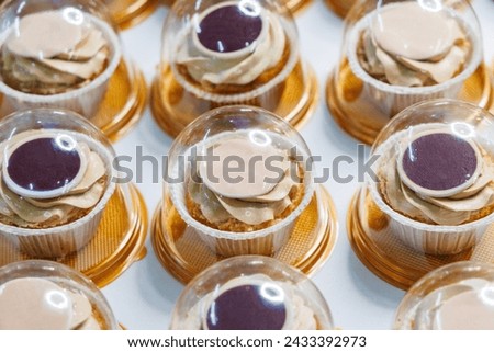 Close-up of colored cupcakes on table in bakery