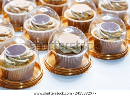 bakery makes luxury handmade cupcakes in plastic packaging for an event catering service