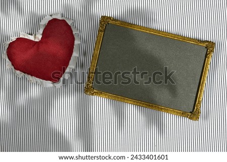 empty golden picture or photo frame mockup with Valentines or women's day heart toy with palm tree shadow on lines background