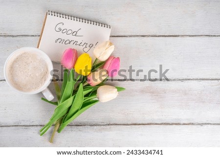 Spring morning with coffee latte cup background with Good morning note and bouquet of tulips flowers. Spring holidays, holiday background, greeting card, top view flat lay copy space