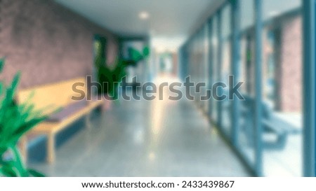 Passage room, corridor with a brick wall on one side and windows on the other side. Blur effect.