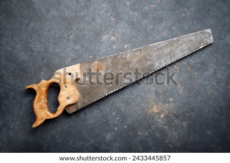 Close up of a disused handsaw on a work bench. Royalty-Free Stock Photo #2433445857
