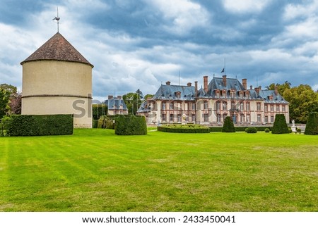 In the Chevreuse Valley is located the “possession of Puss in Boots” - Breteuil Castle. Castle of the noble family of Breteuil. Autumn cloudy day Royalty-Free Stock Photo #2433450041