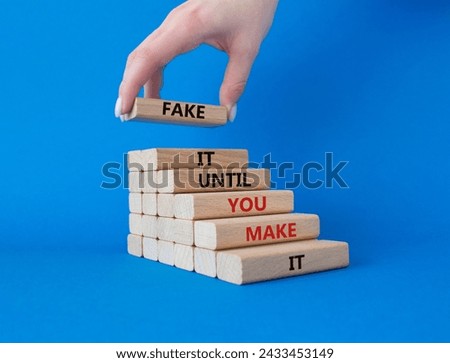 Fake it until you make it symbol. Concept words Fake it until you make it on wooden blocks. Businessman hand. Beautiful blue background. Business concept. Copy space.