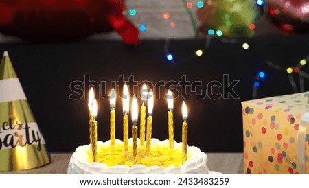 happy boy celebrate birthday at home, friends congratulate with festive cake blowing party whistles make surprise annual tradition. light candles on the cake.