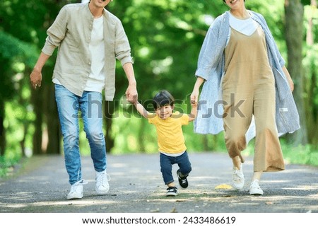 family walking hand in hand in the park
