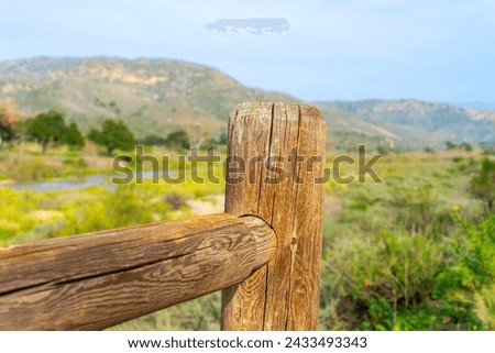 A wooden corral fence with a landscape of Irvine Regional Park in Orange County, California