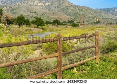 A wooden corral fence with a landscape of Irvine Regional Park in Orange County, California Royalty-Free Stock Photo #2433493345