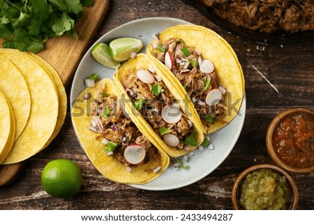 carnitas tacos with salsa and lime