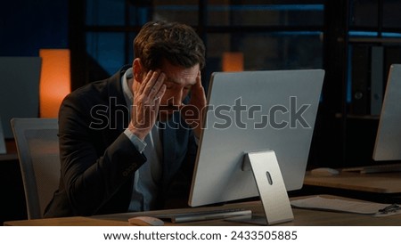 Exhausted Caucasian businessman adult man work overtime in office late night tired entrepreneur worried business problem make mistake failure difficulties with computer read bad news headache stress Royalty-Free Stock Photo #2433505885