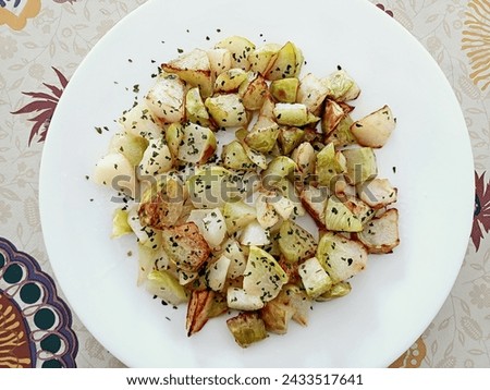 Fried kohlrabi, with oregano, a splash of olive oil and some salt. Royalty-Free Stock Photo #2433517641