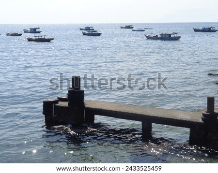 concrete boat quay with fisherman boats background                              Royalty-Free Stock Photo #2433525459