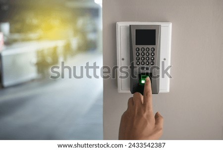 Finger scanner machine Security concept and safety. Businessman hand scanning finger on machine.   Royalty-Free Stock Photo #2433542387